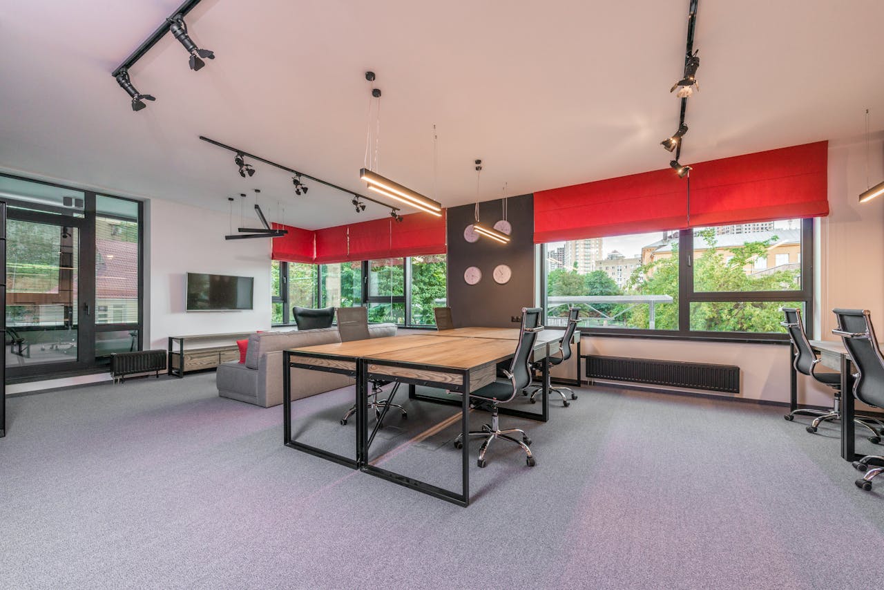 Modern office interior with furniture and lamps against windows